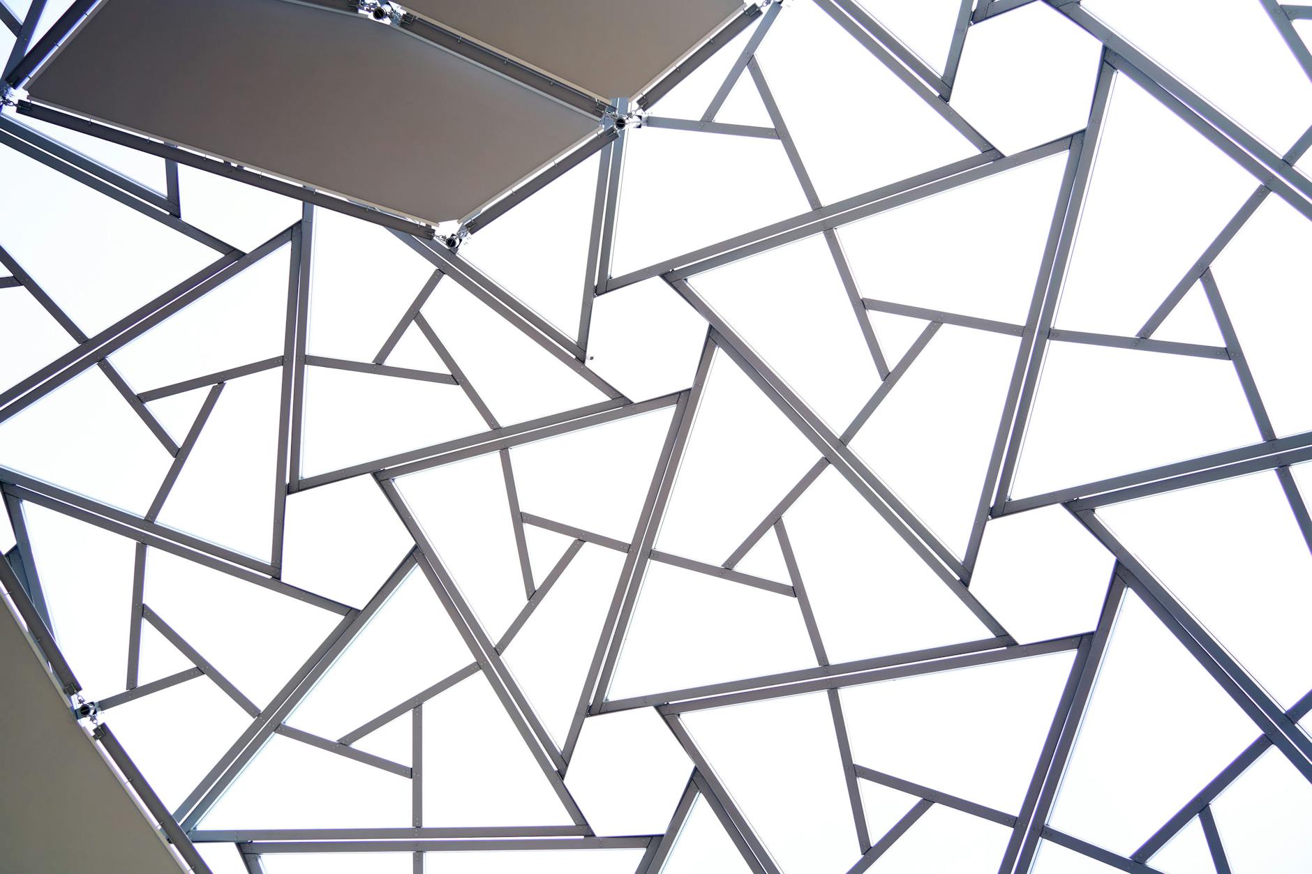Abstract view of a geometric ceiling design with triangular shapes and lines.
