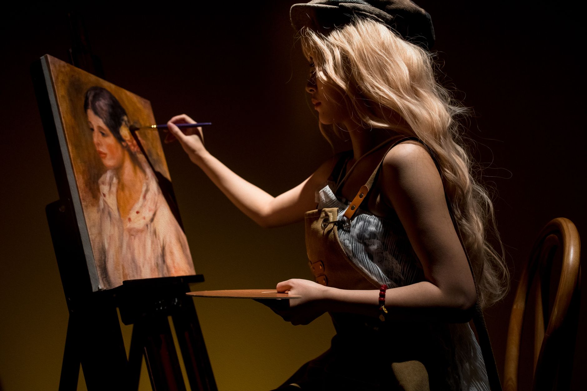 A female artist painting a classic portrait in a softly lit studio setting.