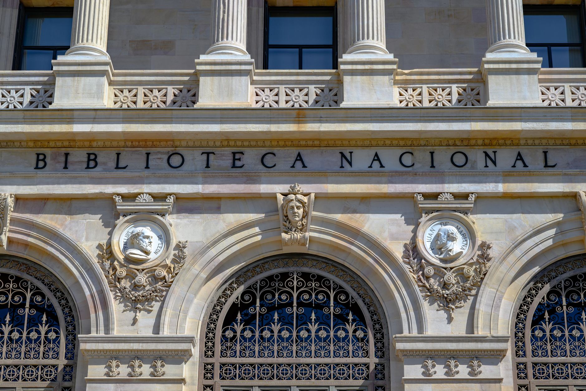 Detailed view of the Biblioteca Nacional facade in Madrid showcasing neoclassical architecture.